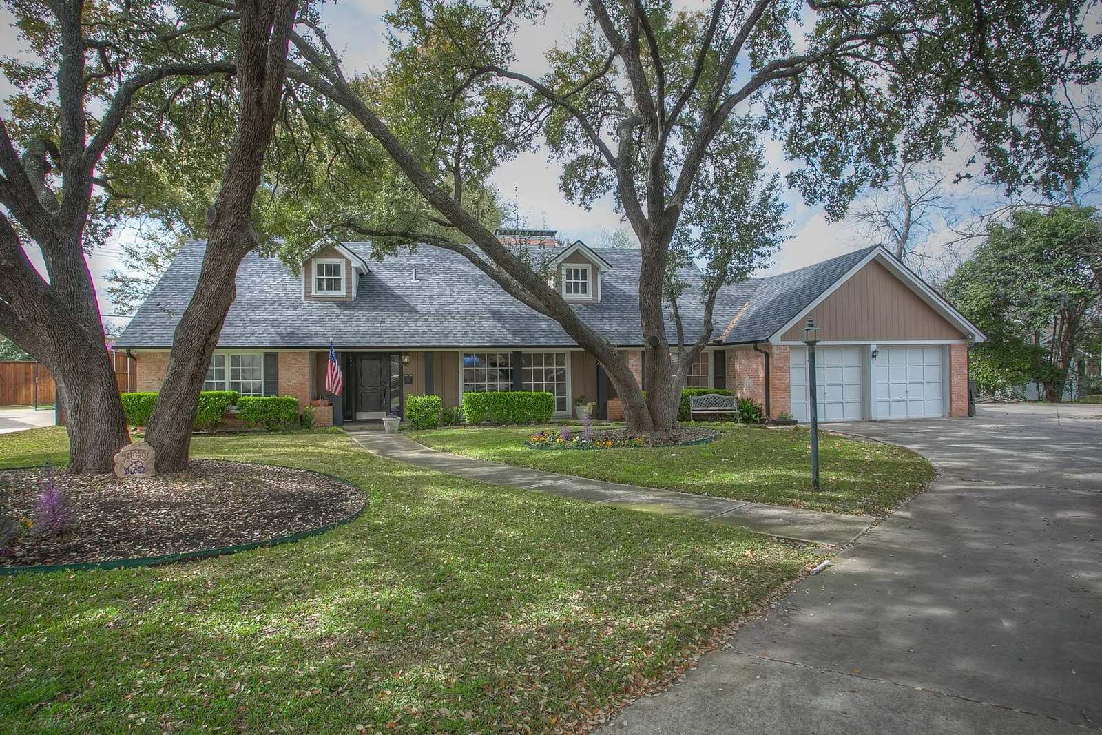 Established residence beneath mature trees in Tanglewood