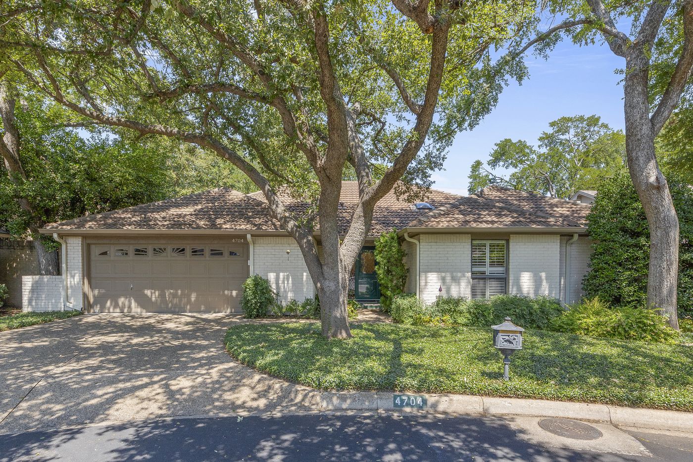 Custom home among mature trees in Overton Woods, Fort Worth