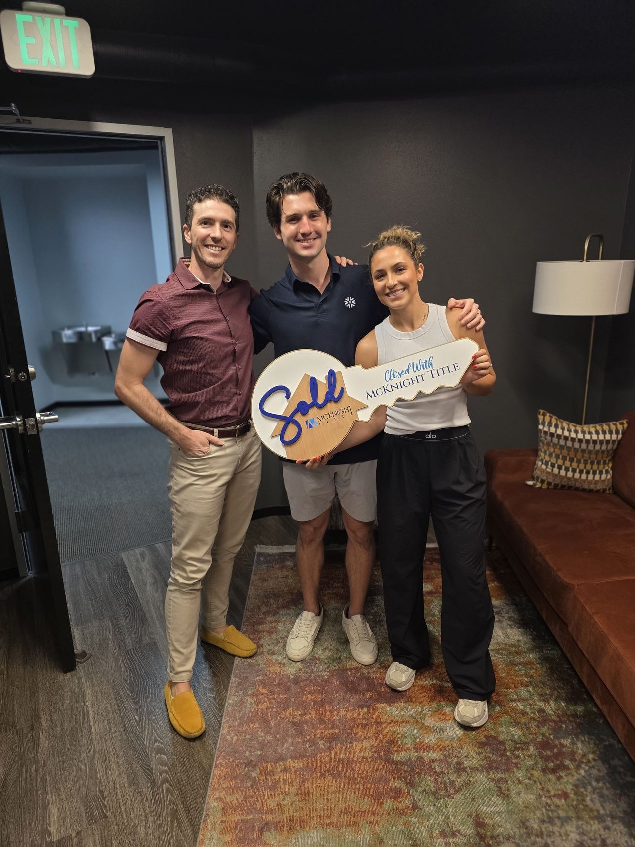 Riley Moyano with his clients at their first-home closing in Hurst, Texas.